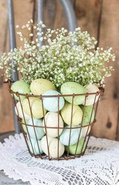 a basket filled with green apples sitting on top of a table