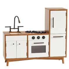 a toy kitchen with white and brown cabinets