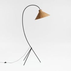 the floor lamp is made from bamboo and has a black metal base with a light brown shade