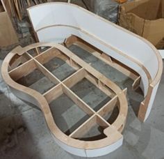 a white bench made out of plywood and wood