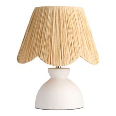 a white table lamp with a beige shade on it's top and bottom half