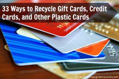 a pile of credit cards sitting on top of a wooden table next to each other