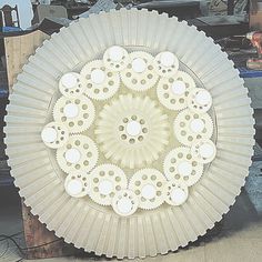 a white plate sitting on top of a table next to other plates and tools in the background