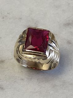 A Classic Mens 14kt Yellow Gold Mens Red Spinel Octagon Shape bezel set in fashion style ring. Finger size 8. total weight is 7.5 grams. This item would Retail for $895.00 Red Rectangular Ring With Polished Finish, Red Rectangular Rings With Polished Finish, Rectangular Red Rings With Polished Finish, Formal Red Rings With Bezel Setting, Formal Ruby Signet Ring With Bezel Setting, Heirloom Red Signet Ring With Polished Finish, Ruby Signet Ring With Bezel Setting For Formal Occasions, Ruby Signet Ring With Polished Finish, Formal Ruby Jewelry With Faceted Details