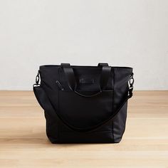 Part of our exclusive West Elm Travel Collection, this lightweight, streamlined tote is perfectly sized for short solo trips or weekends away. It has a removable shoulder strap and secures to our Hardside Spinner Luggage (sold separately) to make traveling in style easy. 17"w x 6.25"d x 14.5"h. Nylon (Black) or polyester (Heather Gray, Heather Blush) body. Bicast leather handles. Removable, adjustable shoulder strap. Large padded pocket for laptops or tablets. Zipper pocket. Perfect for 3-5 days Black Shoulder Bag With Leather Handles For Commuting, Travel Shoulder Bag With Adjustable Handle In Nylon, Nylon Shoulder Bag With Adjustable Handle For Travel, Travel Nylon Shoulder Bag With Adjustable Handle, Nylon Diaper Bag With Adjustable Strap, Nylon Diaper Bag With Adjustable Strap For Daily Use, Travel Nylon Diaper Bag With Adjustable Strap, Travel Diaper Bag With Adjustable Strap In Nylon, Travel Diaper Bag With Adjustable Strap And Nylon Material