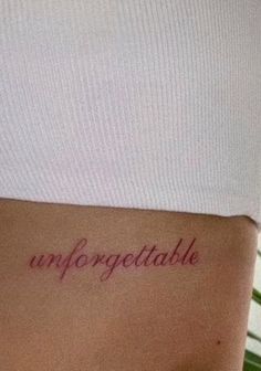 the word unforgettable written in cursive writing on someone's stomach