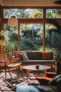 a living room filled with furniture and lots of windows