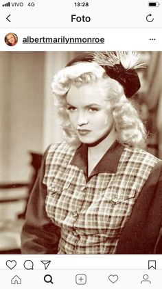 an old black and white photo of a woman with blonde hair wearing a plaid dress