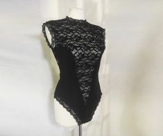 Seductive lace bodysuit with a plunging V and sheer design from 80s-90s. The back is entirely sheer, with a delicate lace design, and features a button loop deep keyhole closure for an added touch of elegance. The bodysuit fastens securely with a hook and eye closure, ensuring a comfortable and snug fit. The scalloped edges around the band collar, armpits, and legs add a touch of vintage charm, while the stretchy fabric ensures it fits perfectly * excellent vintage condition there is a tiny defe Style Collage, Corset Bodysuit, Vintage Goth, Lace Corset, Band Collar, Scalloped Edges, Lace Bodysuit, Lace Design, Womens Bodysuit