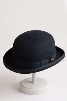 Top off your seasonal presentation with the charming Wool Bowler. Fashioned in 100% wool felt with its signature 3 3/4" tall dome crown and a wide grosgrain bow trim with pin, this classic design boasts a bound edge brim with a signature shape that's structured and curved. On the inside, there's a pleated satin lining, a clear plastic barrier, and a smooth comfort sweatband for a snug fit. Dare to look dashing. Luxury Classic Wool Boater Hat, Classic Fitted Wool Boater Hat, Luxury Wool Boater Hat With Curved Brim, Classic Adjustable Wool Boater Hat, Classic Wool Top Hat, Interesting Dress, Ivy Hat, Skull Top, Round Hat