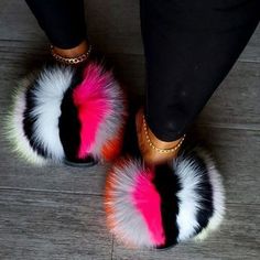 two women's feet wearing colorful furry slippers