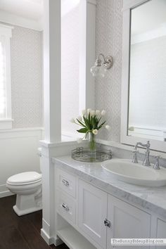 a white bathroom with two sinks and a toilet