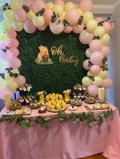 a table with balloons and desserts on it