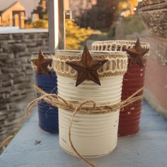 three jars with twine and star decorations are sitting on a table