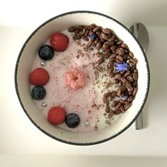 a bowl filled with yogurt, berries and granola