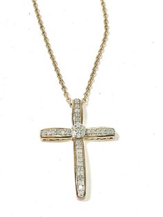 a diamond cross necklace on a gold chain