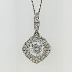 This piece is luxuriously crafted in solid 14k white gold and the natural diamonds radiate gracefully from the mounting. They also beautifully highlight the gorgeous round center colorless moissanite.   Add shimmer to your day or evening look with this double halo moissanite & diamond pave pendant.  The chain is included in the price. * Description: *Length: 13mm (without bail) * Metal purity: solid 14k white gold *Center Stone:6.5mm (DEW 1ct) moissanite * Center Stone Quality: VS-VVS clarity an Dazzling Platinum Diamond Necklace, Diamond White Brilliant Cut Cubic Zirconia Necklace, Silver Diamond Necklace With Round Cut, Dazzling White Diamond-cut Necklace, Wedding Diamond Necklace In 14k White Gold, Timeless Moissanite Diamond Necklace For Wedding, Dazzling White Gold Diamond Cut Necklace, Dazzling Silver Diamond Necklace With Halo Setting, Luxury Diamond Necklace With Halo Setting