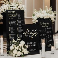 wedding seating chart with white flowers and candles on the table in front of black menus