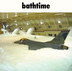 an airplane that is in some kind of building with the words bathtime on it