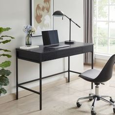 a black desk with a laptop on it and a chair in front of the desk