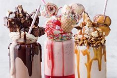 three milkshakes with different toppings are lined up