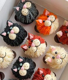 cupcakes decorated with different types of animals in a box