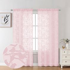 a pink curtain hanging in front of a window with an image of flowers on it