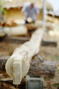 a man is working on a piece of wood