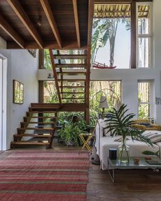 a living room filled with furniture and a stair case