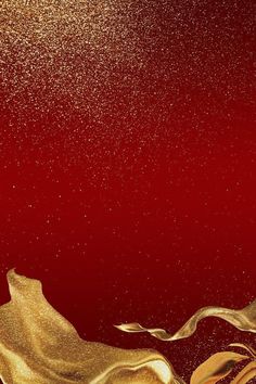 an abstract gold and red background with some glitter on the bottom half of the image