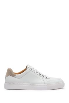 White shoes always add a fresh and clean look to an outfit. This leather sneaker is sporty yet classy with contrasting suede details and sleek silhouette.Sizing: True to size. Round toe. Leather construction. Suede heel detail. Lace-up closure. Padded footbed. White sole. Imported White Suede High-top Sneakers With Textured Sole, Classic White Suede Sneakers, White High-top Sneakers For Streetwear With Stitched Sole, White Suede Round Toe Platform Sneakers, White Suede Platform Sneakers, White Suede High-top Sneakers For Sports, White Low-top Sneakers With Stitched Sole, White Suede Platform Sneakers With Textured Sole, White Suede Mid-top Sneakers