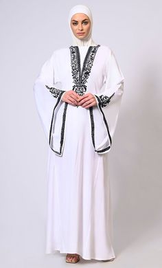 White Abaya with Bell Sleeves adorned in Hand & Machine Embroidery - EastEssence.com Elegant Long Sleeve Abaya With Embroidered Border, Elegant Floor-length Thobe With Floral Embroidery, Long Sleeve Thobe With Intricate Embroidery For Eid, Eid Thobe With Intricate Embroidery Long Sleeve, Eid Thobe With Intricate Embroidery, Modest Long Embroidered Kaftan, White Long Sleeve Abaya With Floral Embroidery, Elegant Long Sleeve Thobe With Floral Embroidery, Spring Wedding Embroidered Abaya