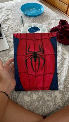 someone is painting a spider man on the bed