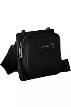 Elevate your accessory game with the Calvin Klein Shoulder Bag, where functionality meets urban chic. Crafted from premium materials, 95% Polyester and 5% Polyethylene, this sleek black bag is a testament to Calvin Klein’s commitment to eco-conscious fashion with 60% recycled polyester. It features an adjustable and removable strap for versatile styling, an external pocket for easy access, and signature contrasting details that highlight the brand’s eye for design. Zip closure secures your belon Modern Black Nylon Bag, Modern Nylon Bags For Commuting, Modern Calvin Klein Bags With Detachable Strap, Urban Nylon Bags For Commuting, Modern Nylon Bag For Commuting, Business Nylon Shoulder Bag With Detachable Strap, Business Shoulder Bag With Detachable Strap In Nylon, Calvin Klein Travel Bag With Removable Pouch, Trendy Nylon Bags For Commuting