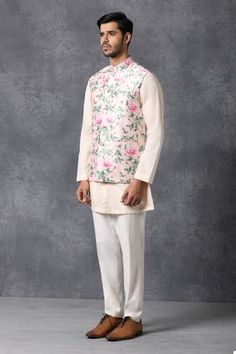 Blush pink Nehru jacket with floral motifs, front button placket and patch pocket.
Components: 1
Fabric: Cotton, Silk 
Neckline: Mandarin
Sleeve Length: Sleeveless
Color: Pink
Printed
Note: Inner kurta and pant worn by the model is not for sale - Aza Fashions Spring White Nehru Jacket With Floral Print, Fitted Pink Nehru Jacket With Floral Embroidery, Traditional Nehru Jacket For Spring Workwear, Nehru Jacket For Men, Nehru Jacket, Nehru Jackets, Jacket For Men, Floral Motifs, Pink Cotton