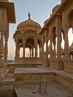 an intricately carved building with pillars and arches