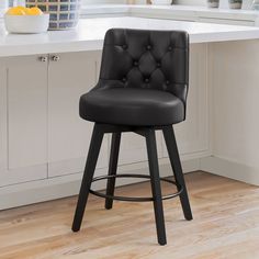 a black leather bar stool sitting on top of a kitchen counter