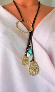 Lovely Leather Lariat necklace. Genuine Turquoises tassel, Unique design NEW vacation Jewelry purchase, never used This is a stunning statement necklace Components include: shiny gold tone quality Brass Genuine 31 inch flat Leather 6 inch Leather Tassel with stone and Brass dangles Handmade in Asia Ready to ship NO waiting Only ONE necklace available Thank you so much for visiting :kaysclassyboutique@etsy.com Adjustable Metal Tassel Necklace As Gift, Bohemian Metal Lariat Necklace With Adjustable Length, Bohemian Lariat Necklace With Tassels, Bohemian Metal Tassel Necklace As Gift, Bohemian Gold Tassel Necklace For Gift, Bohemian Gold Tassel Necklace As Gift, Bohemian Gold Tassel Necklace, Adjustable Turquoise Elegant Lariat Necklace, Adjustable Elegant Tassel Necklace For Festival