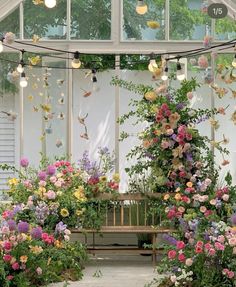 a wooden bench surrounded by lots of flowers