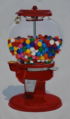 a red gummy machine filled with lots of colorful candies on top of it