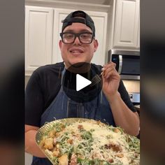 a man wearing glasses and an apron holding a plate with food on it in front of him