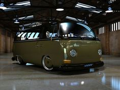 an old vw bus is parked in a garage