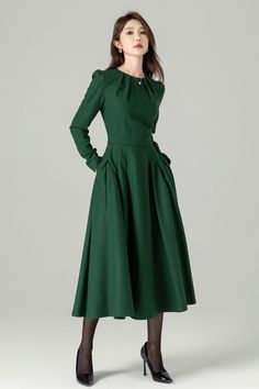 "Green long sleeve wool swing dress with a stylish folded neckline. This dress effortlessly blends elegance and comfort. The flared silhouette offers a graceful and flattering fit, while the high-quality wool fabric ensures warmth and softness. The folded neckline adds a touch of sophistication to this versatile dress, perfect for various occasions. DETAIL * 30% wool, 30% fiber, 40% polyester * fully satiny lining, more nice to the touch body * Round pleated neckline * Long sleeves * Fit and fla Elegant Full Skirt Dress For Fall, Winter Long Sleeve Fit And Flare Dress, Winter Fit And Flare Dress With Long Sleeves, Fit And Flare Long Sleeve Winter Dress, Fitted Long Sleeve A-line Dress For Winter, Fitted A-line Long Sleeve Winter Dress, Fall Wedding Pleated Dress, Fall Wedding Dress With Pleated Details, Wool Long Sleeve Midi Dress For Spring