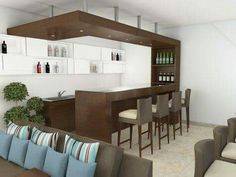 a living room filled with furniture and lots of counter top space next to a bar