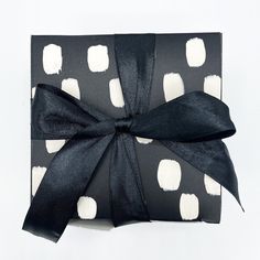 a black and white polka dot wrapped present