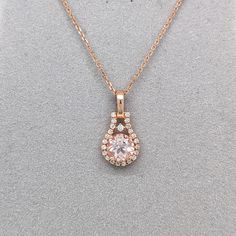 This cute pendant features a 0.70 carat pink Morganite with natural earth mined diamonds set in solid 14K gold. This Morganite pendant makes a beautiful June birthstone gift for your loved ones! This pendant is made with solid 14k Gold and natural Earth mined SI / G-H diamonds. As listed, this pendant is ready to ship. If you're interested in purchasing this setting with a different center stone please message us! Rose Gold Teardrop Pendant Diamond Necklace, Rose Gold Teardrop Diamond Necklace, Rose Gold Morganite Jewelry With Vvs Clarity, Dazzling Necklace With Center Stone As Gift, Rose Gold Morganite Jewelry With Brilliant Cut, Dazzling Necklace With Center Stone For Gift, Rose Gold Flower Pendant With Brilliant Cut, Rose Gold Brilliant Cut Flower Pendant Jewelry, Fine Jewelry Diamond Necklace With Center Stone As Gift