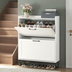 a white shoe cabinet sitting next to a stair case