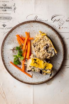 a white plate topped with meat and veggies