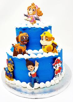 a blue cake with cartoon characters on it