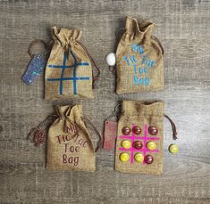 three bags filled with candy sitting on top of a wooden table